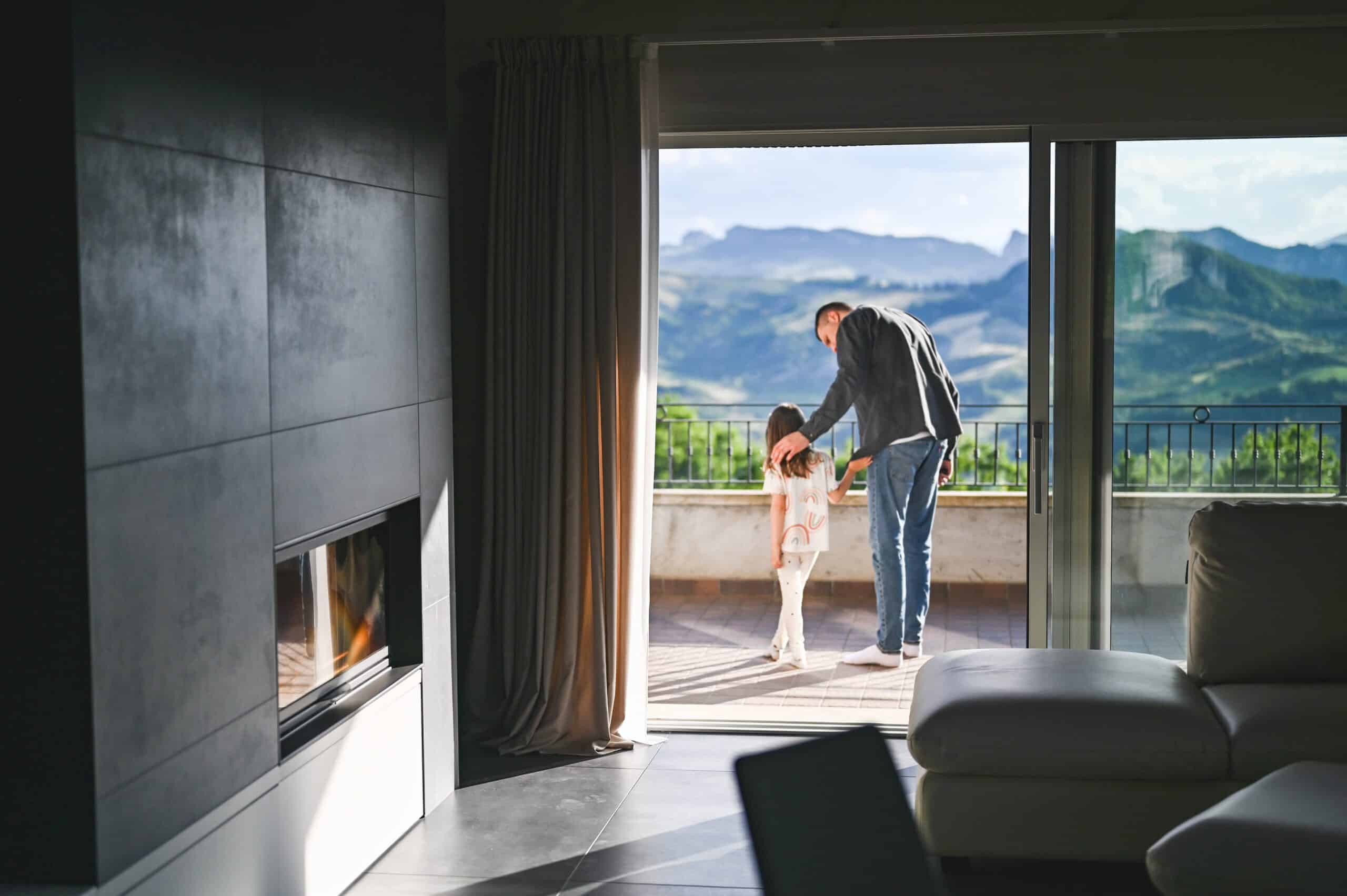 father helping daughter on balcony
