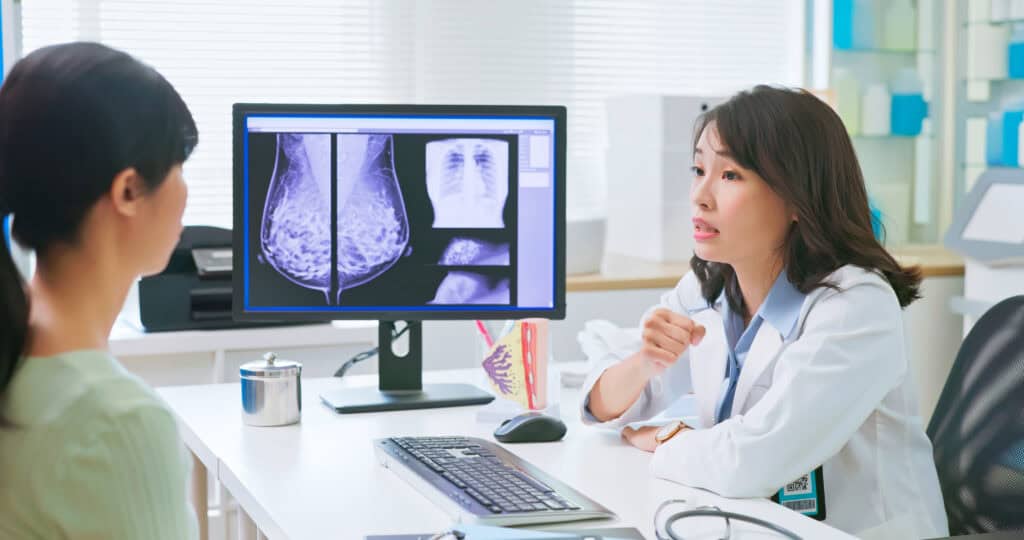 A doctor discuss the results of a mammogram with her patient.